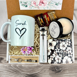 gift basket with a personalized heart coffee mug, engraved spoon, vibrant coaster, scented candle, artisan charm, and coffee treats for women’s presents