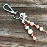 Copper Butterfly Beaded Charm
Delicate butterfly charm with premium gemstone beads and rustic copper findings, clipped to a handbag or luggage.