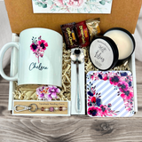  gift basket with a personalized purple coffee mug, engraved spoon, vibrant coaster, scented candle, artisan charm, and coffee treats for women’s present