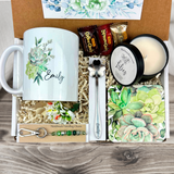 gift basket with a personalized succulent coffee mug, engraved spoon, vibrant coaster, scented candle, artisan charm, and coffee treats for women’s present